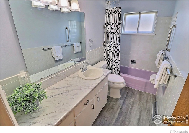821 36th Ave, Greeley, CO 80634 - full bathroom with tile walls, toilet, vanity, shower / bath combination with curtain, and wood finished floors