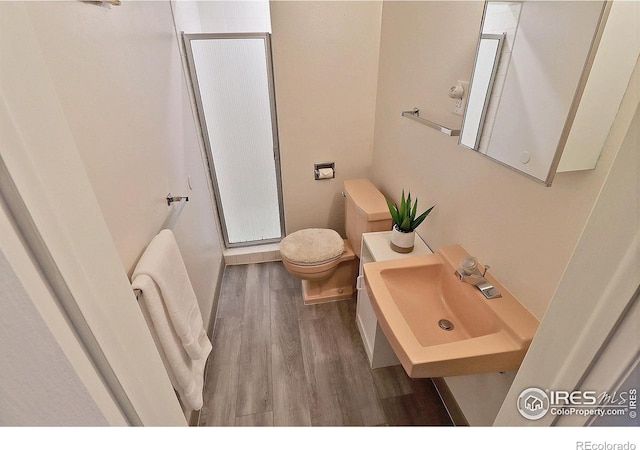 821 36th Ave, Greeley, CO 80634 - full bath featuring a stall shower, a sink, wood finished floors, toilet, and baseboards