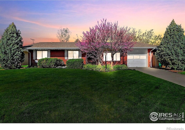 821 36th Ave, Greeley, CO 80634 - view of front of home featuring brick siding, concrete driveway, a garage, and a lawn
