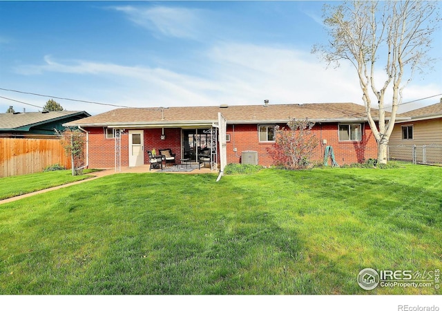 821 36th Ave, Greeley, CO 80634 - back of property featuring a patio, brick siding, and central air condition unit