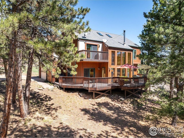 187 Rocky Knob Ln, Nederland, CO 80466 - back of property with a shingled roof, a balcony, and a deck
