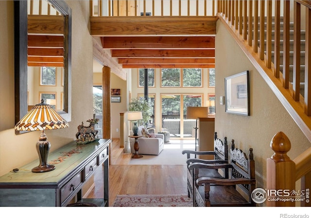187 Rocky Knob Ln, Nederland, CO 80466 - living area with stairs, a textured wall, wood finished floors, and a wealth of natural light