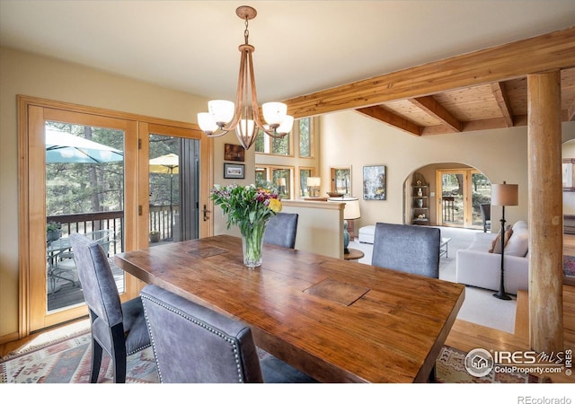 187 Rocky Knob Ln, Nederland, CO 80466 - dining area with arched walkways, beamed ceiling, an inviting chandelier, and wood finished floors