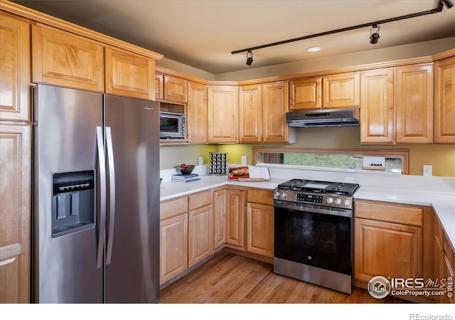 187 Rocky Knob Ln, Nederland, CO 80466 - kitchen featuring under cabinet range hood, appliances with stainless steel finishes, track lighting, and light wood finished floors