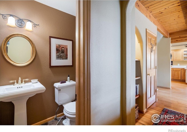 187 Rocky Knob Ln, Nederland, CO 80466 - bathroom featuring a textured wall, wood finished floors, toilet, wood ceiling, and a sink