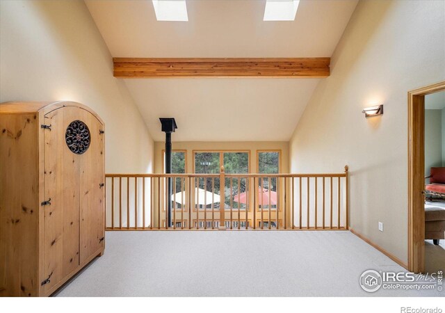 187 Rocky Knob Ln, Nederland, CO 80466 - corridor featuring carpet flooring, baseboards, and lofted ceiling with skylight
