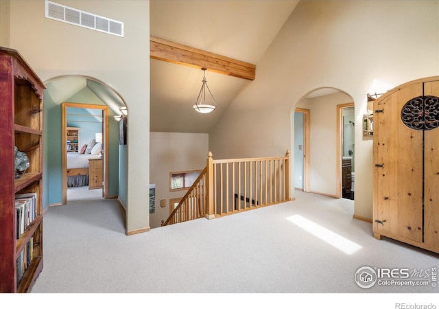 187 Rocky Knob Ln, Nederland, CO 80466 - corridor featuring carpet floors, visible vents, arched walkways, and an upstairs landing