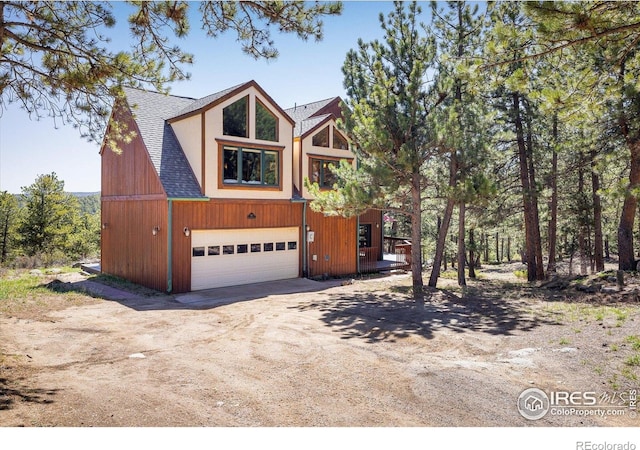 187 Rocky Knob Ln, Nederland, CO 80466 - rustic home with roof with shingles, driveway, and a garage