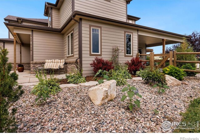1105 Shelby Dr, Berthoud, CO 80513 - view of side of home with a patio
