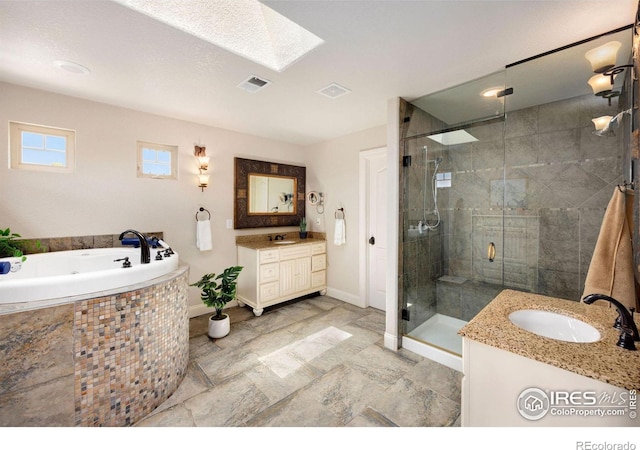 1105 Shelby Dr, Berthoud, CO 80513 - bathroom with vanity, a skylight, a stall shower, a tub with jets, and baseboards
