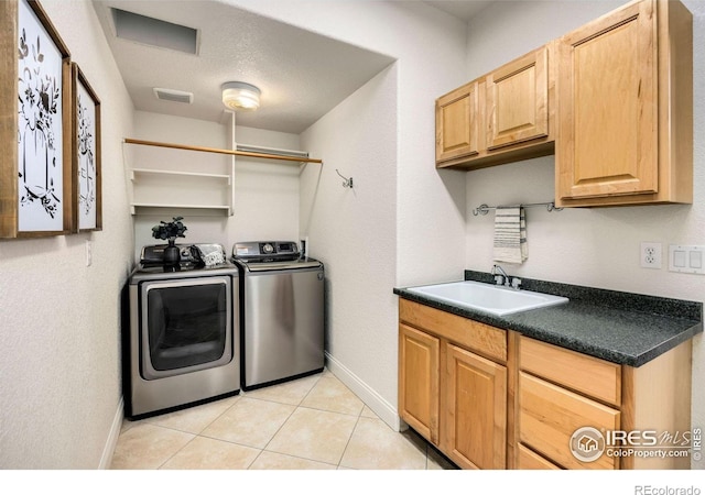1105 Shelby Dr, Berthoud, CO 80513 - laundry room with baseboards, independent washer and dryer, cabinet space, and light tile patterned floors