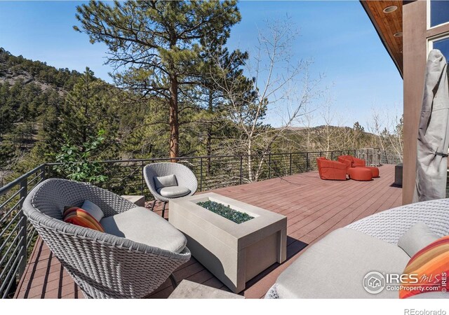 wooden deck with an outdoor fire pit