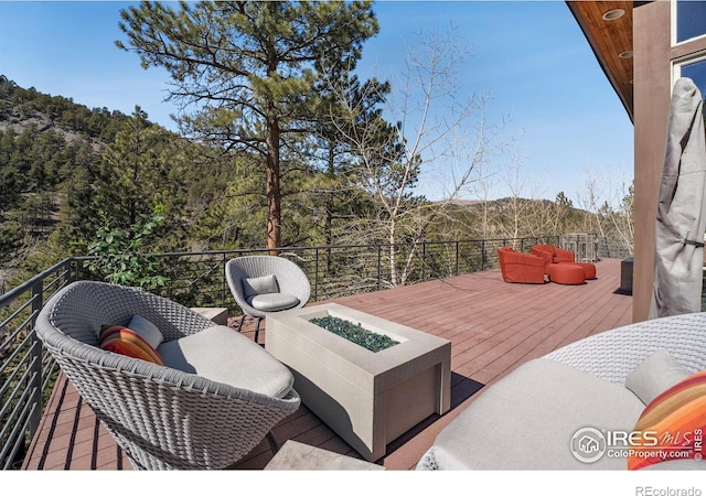 1127 Valley Ln, Boulder, CO 80302 - wooden deck with an outdoor fire pit