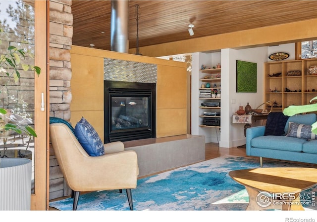 1127 Valley Ln, Boulder, CO 80302 - living area featuring a glass covered fireplace, wooden ceiling, built in shelves, and wood finished floors