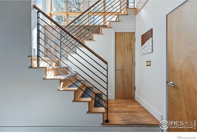 1127 Valley Ln, Boulder, CO 80302 - stairway with baseboards and wood finished floors