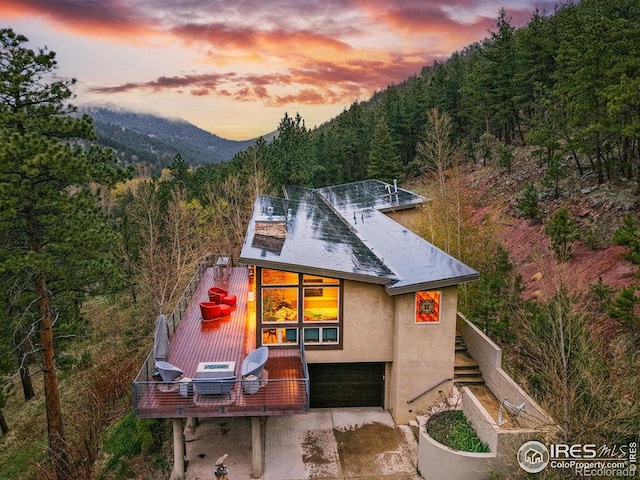 1127 Valley Ln, Boulder, CO 80302 - rear view of house with a mountain view, stucco siding, stairway, and a forest view