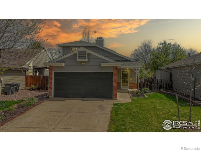 view of front of house featuring fence, a front lawn, brick siding, a chimney, and concrete driveway