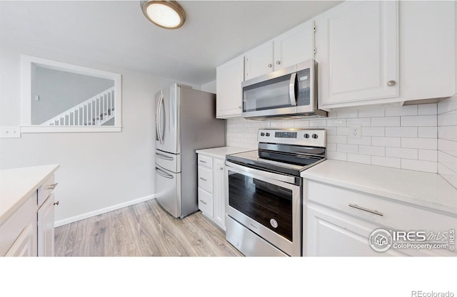 2330 Redwood Ave, Lafayette, CO 80026 - kitchen with light countertops, appliances with stainless steel finishes, white cabinets, and decorative backsplash