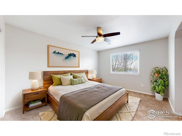 bedroom with baseboards, light carpet, and ceiling fan
