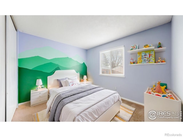 bedroom featuring baseboards and carpet flooring