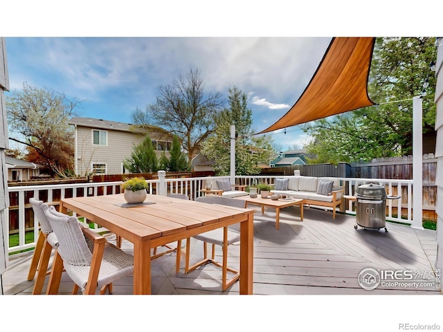 wooden terrace with a fenced backyard, outdoor dining space, and an outdoor living space