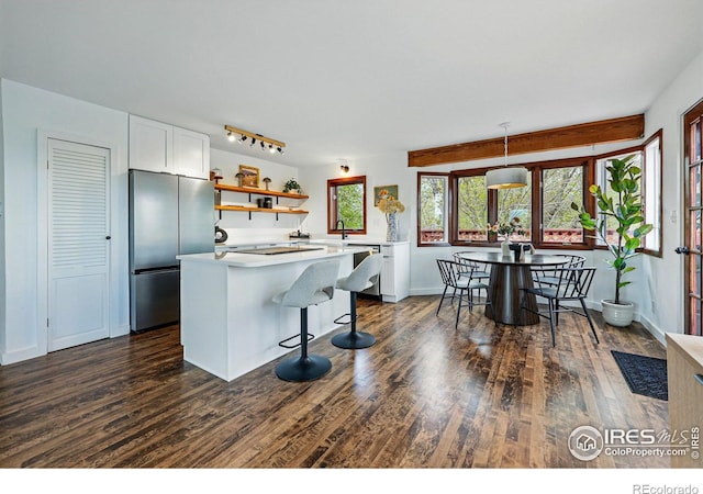 4731 Jay Rd, Boulder, CO 80301 - kitchen featuring appliances with stainless steel finishes, open shelves, white cabinetry, dark wood-style flooring, and light countertops