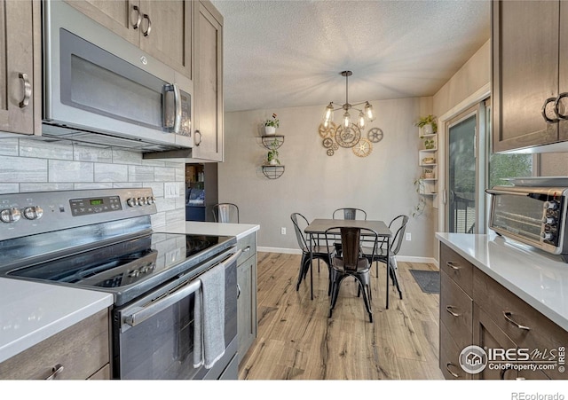 150 Lori Dr, Loveland, CO 80537 - kitchen featuring baseboards, appliances with stainless steel finishes, light wood-style flooring, and a toaster