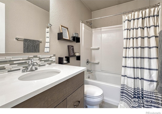 150 Lori Dr, Loveland, CO 80537 - full bath featuring vanity, shower / tub combo with curtain, a textured wall, and decorative backsplash