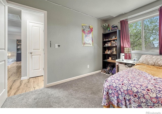 150 Lori Dr, Loveland, CO 80537 - carpeted bedroom with a textured wall and baseboards