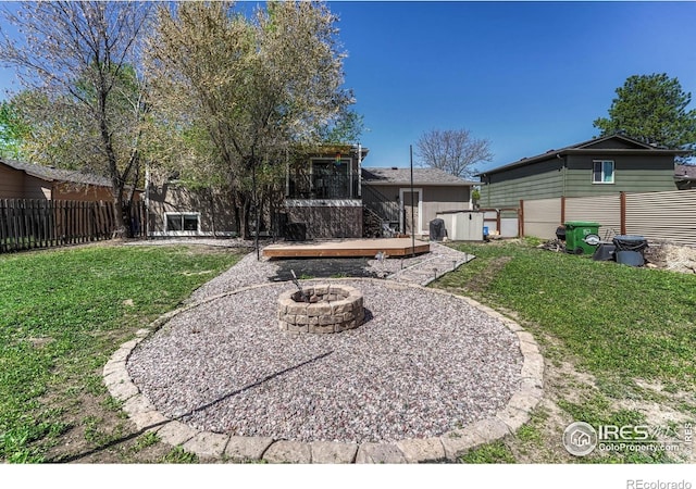 150 Lori Dr, Loveland, CO 80537 - view of yard featuring a patio, a fenced backyard, and an outdoor fire pit