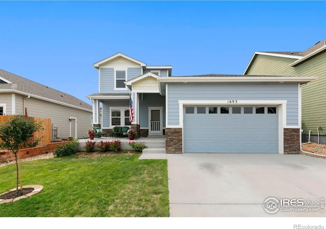1693 Maseca Plaza Way, Severance, CO 80550 - view of front facade with covered porch, stone siding, an attached garage, driveway, and a front yard
