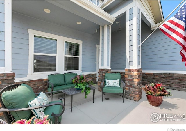 1693 Maseca Plaza Way, Severance, CO 80550 - covered porch featuring outdoor lounge area