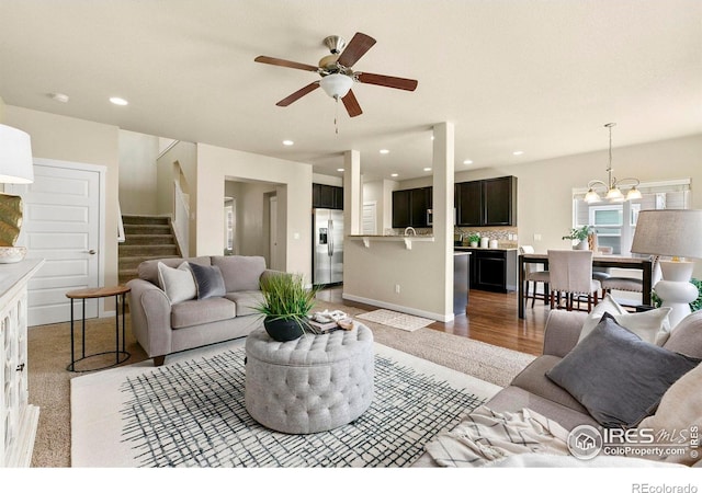 1693 Maseca Plaza Way, Severance, CO 80550 - living area with stairs, ceiling fan, recessed lighting, a chandelier, and light wood-style flooring