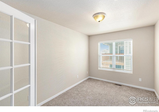 1693 Maseca Plaza Way, Severance, CO 80550 - empty room featuring carpet flooring, baseboards, and a textured ceiling