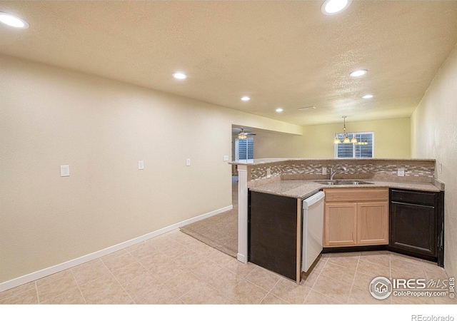 1693 Maseca Plaza Way, Severance, CO 80550 - kitchen with a sink, recessed lighting, dishwashing machine, a peninsula, and baseboards