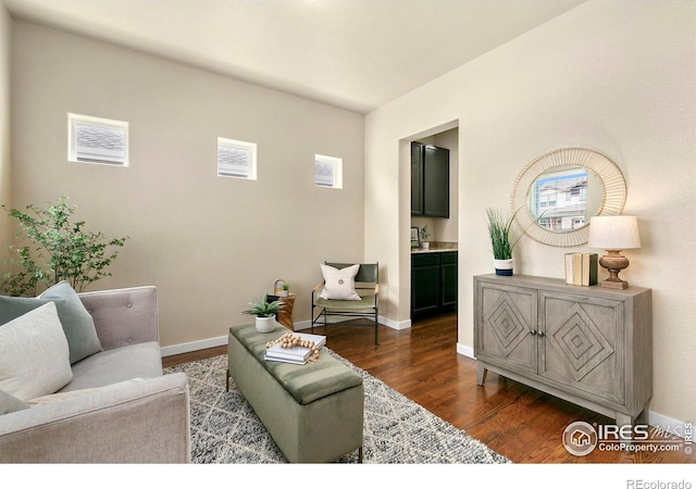 1693 Maseca Plaza Way, Severance, CO 80550 - living room featuring dark wood-type flooring, plenty of natural light, and baseboards