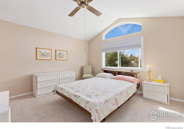 carpeted bedroom with baseboards, ceiling fan, and vaulted ceiling