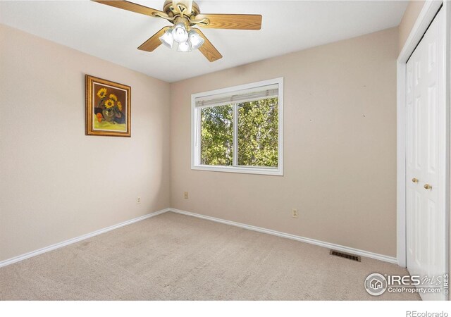 unfurnished bedroom with carpet floors, baseboards, a closet, and visible vents