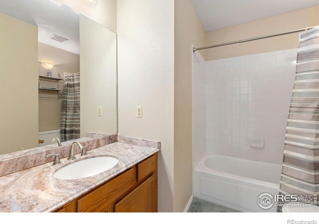 full bath with visible vents, shower / bath combo with shower curtain, and vanity