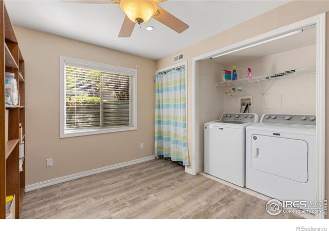 laundry area with a ceiling fan, visible vents, washing machine and clothes dryer, baseboards, and light wood finished floors