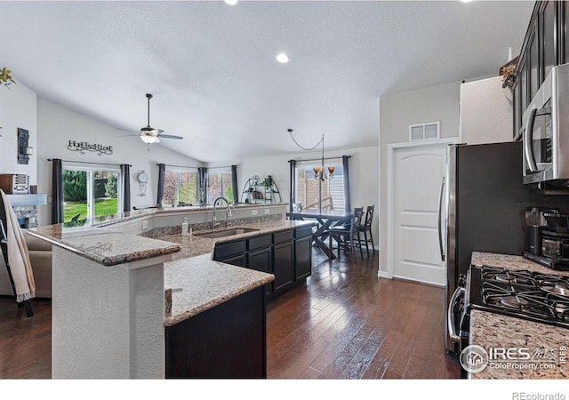 725 Canyonlands St, Berthoud, CO 80513 - kitchen featuring black range with gas cooktop, dark wood-style flooring, visible vents, a sink, and stainless steel microwave