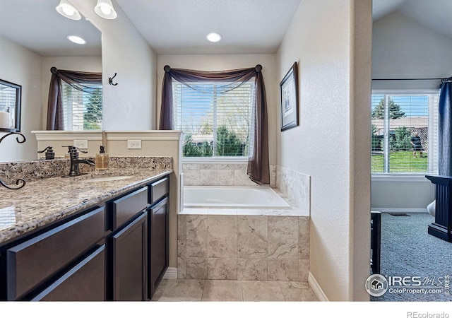 725 Canyonlands St, Berthoud, CO 80513 - full bath featuring tiled bath, baseboards, and vanity