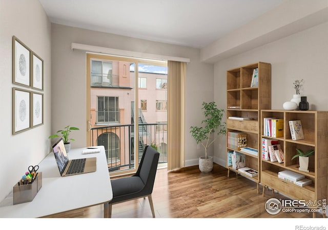 home office featuring baseboards and wood finished floors