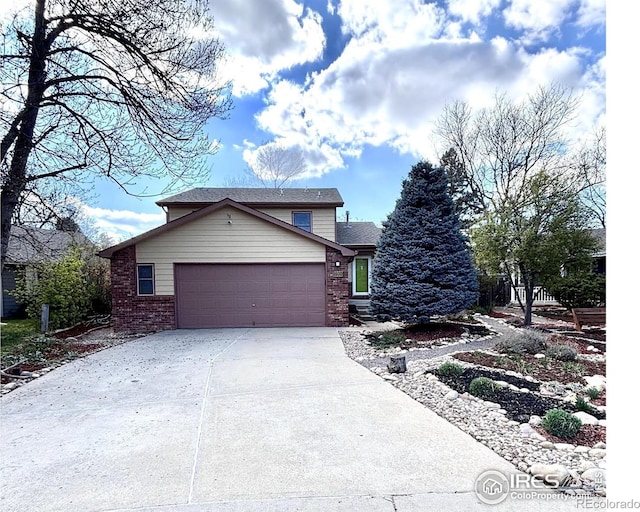 1600 Dogwood Ct, Fort Collins, CO 80525 - view of front of home featuring brick siding, a garage, and concrete driveway