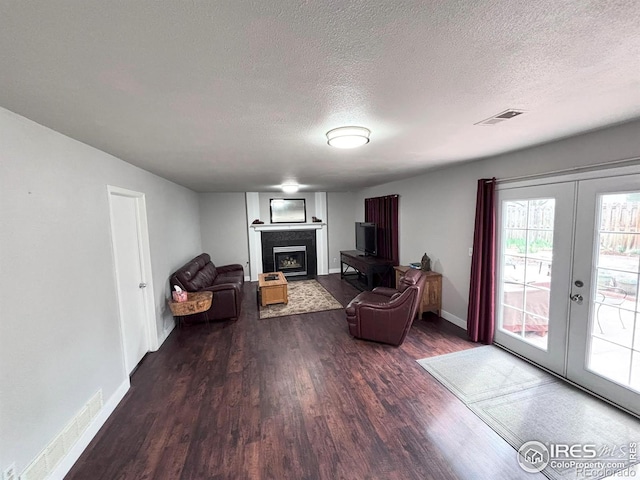 1600 Dogwood Ct, Fort Collins, CO 80525 - living area featuring french doors, a textured ceiling, visible vents, a fireplace, and wood finished floors