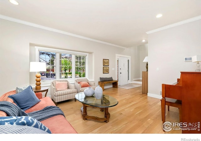 living area with recessed lighting, ornamental molding, light wood finished floors, and baseboards