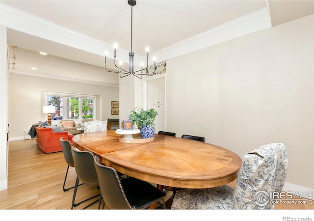 dining space with crown molding, light wood-style floors, recessed lighting, and a notable chandelier