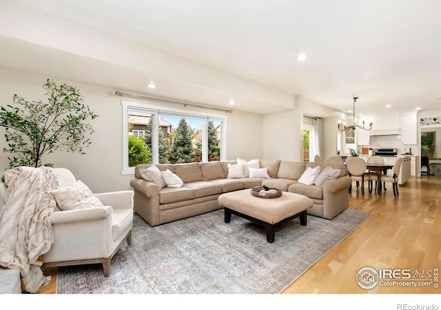 living room featuring recessed lighting, plenty of natural light, and light wood-style floors