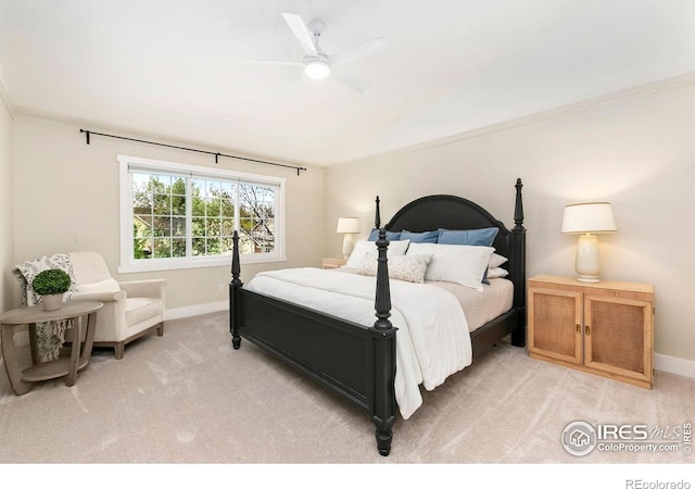 bedroom with baseboards, a ceiling fan, crown molding, and light colored carpet
