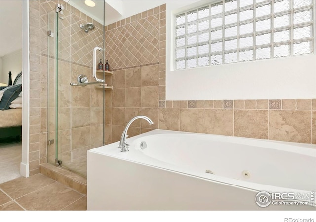 ensuite bathroom with tile patterned floors, a stall shower, a bath, and connected bathroom
